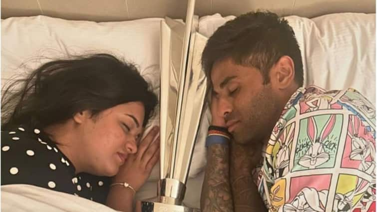 Suryakumar Yadav Devisha Shetty Pose T20 World Cup Trophy in Bed Viral Pics Suryakumar Yadav Poses With T20 World Cup Trophy In Bed: See Viral Pics